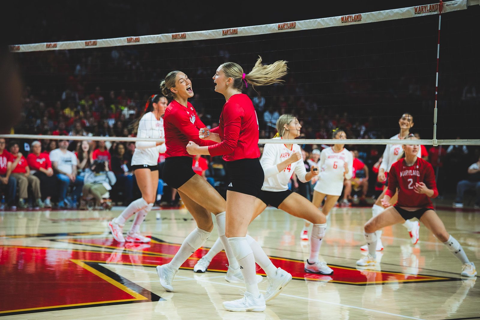 Nebraska Huskers volleyball players celebrating together on court during the 2026 sweep at Maryland.
