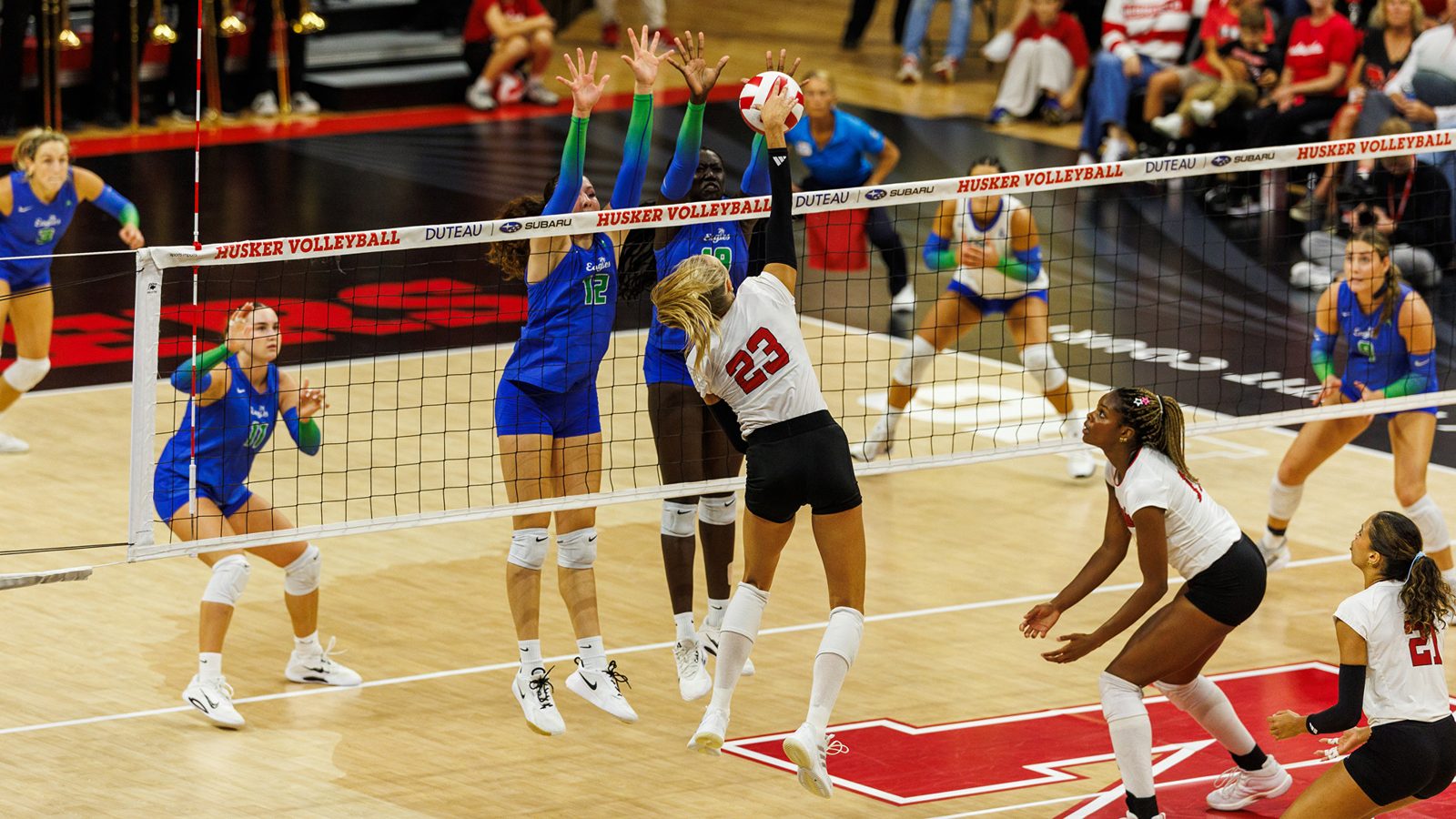 Nebraska Huskers volleyball attacking at the net in front of a two-player block at the Bob Devaney Sports Center, 2026 season.