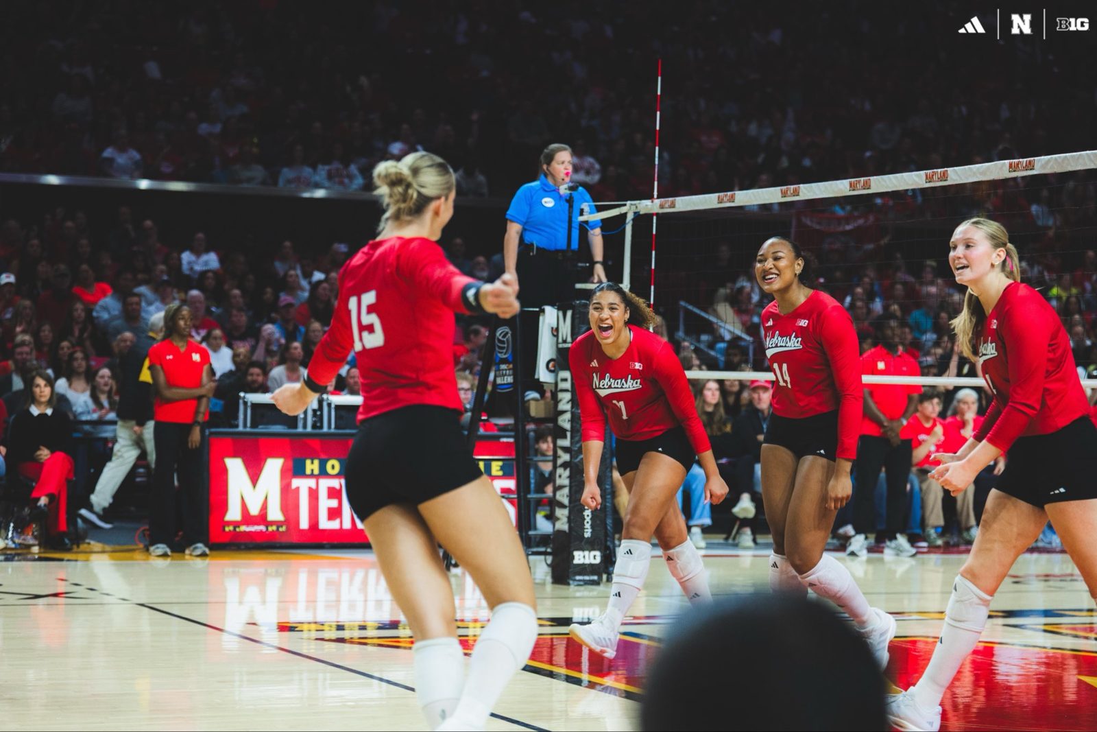 Nebraska Huskers volleyball players in red on court at Maryland.