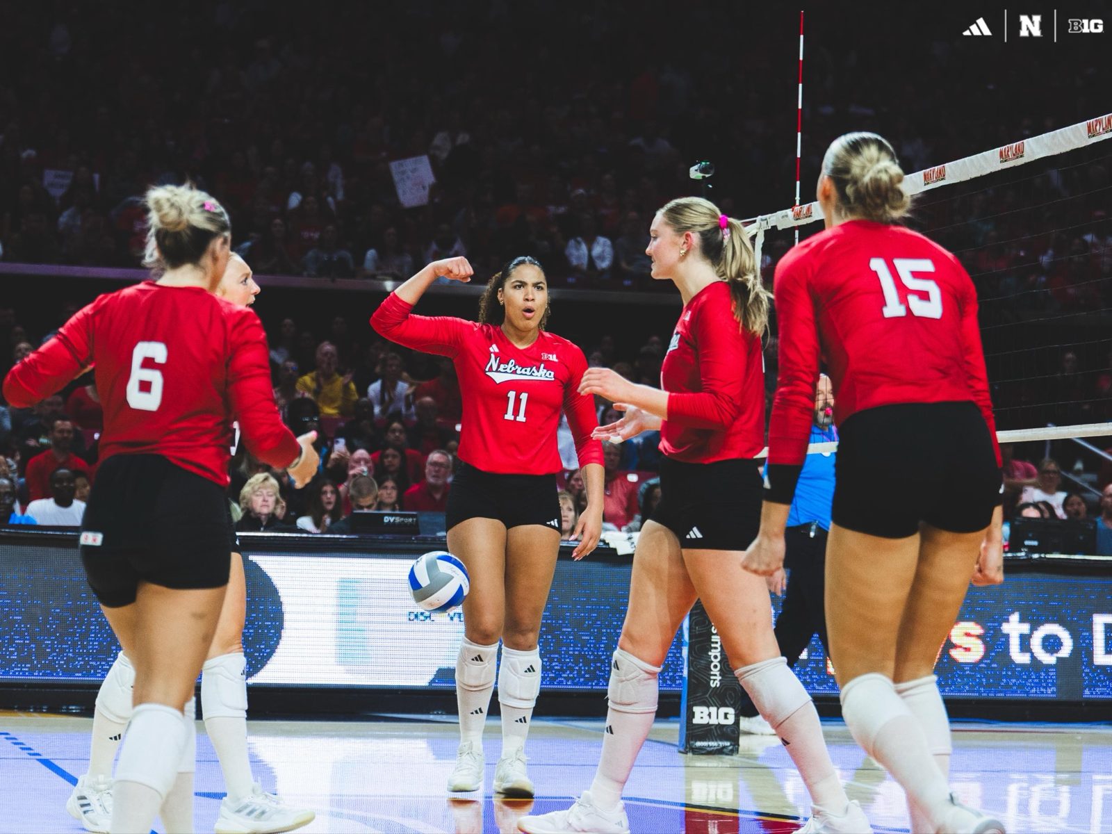 Nebraska Huskers volleyball players celebrating a point at Maryland.